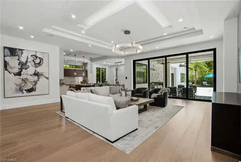 a living room with furniture and large windows