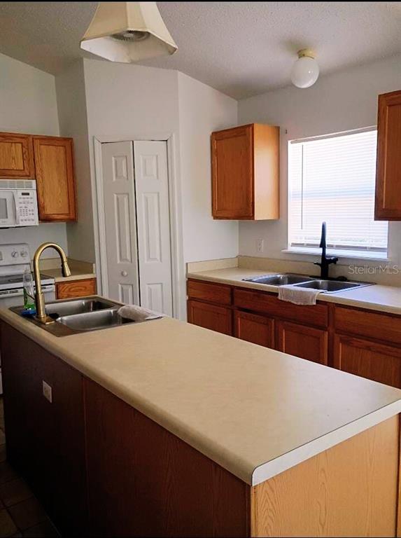 10367 Flycatcher Road Brooksville, FL 34613 - Photo 4 of 10 a kitchen with a sink and a stove
