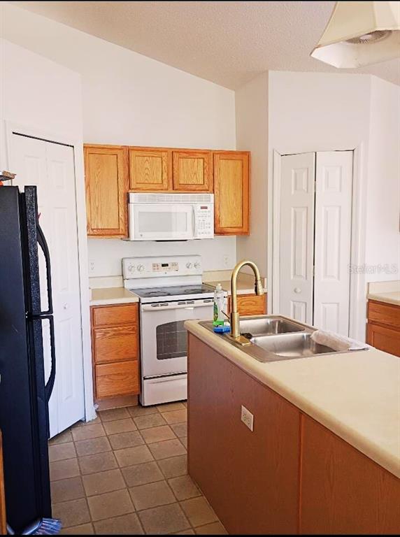 10367 Flycatcher Road Brooksville, FL 34613 - Photo 5 of 10 a kitchen with stainless steel appliances a refrigerator sink and cabinets