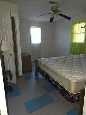 en empty room with windows and fan