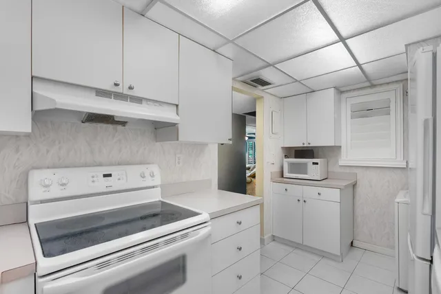 a kitchen with cabinets appliances and a counter space
