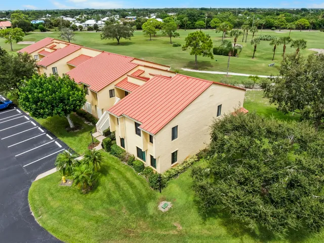 an aerial view of a house with a big yard