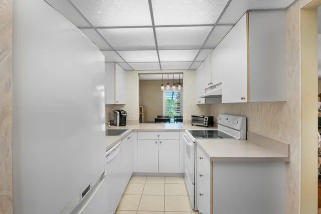 a kitchen with a sink cabinets and window