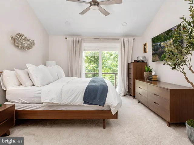 a front view of a house with a garden and yard