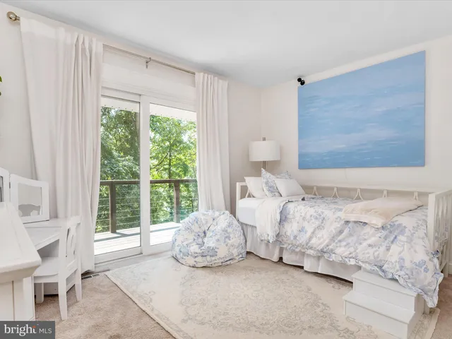 a view of deck with furniture and trees