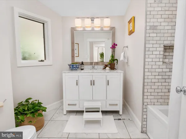 a view of a house with wooden deck and furniture
