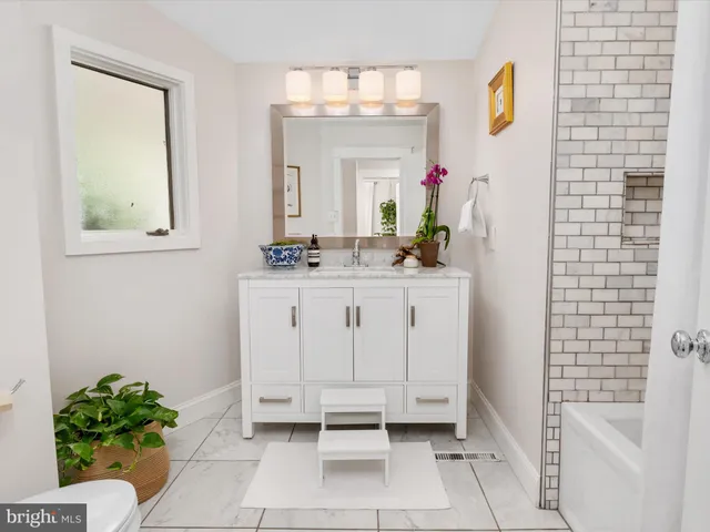 a view of a house with wooden deck and furniture