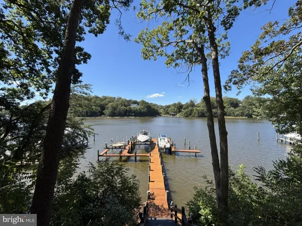 a living room with fireplace furniture and a large window