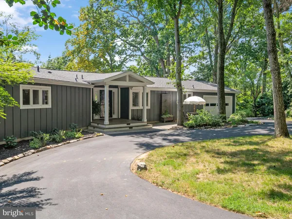 an aerial view of a house with garden space and sitting area