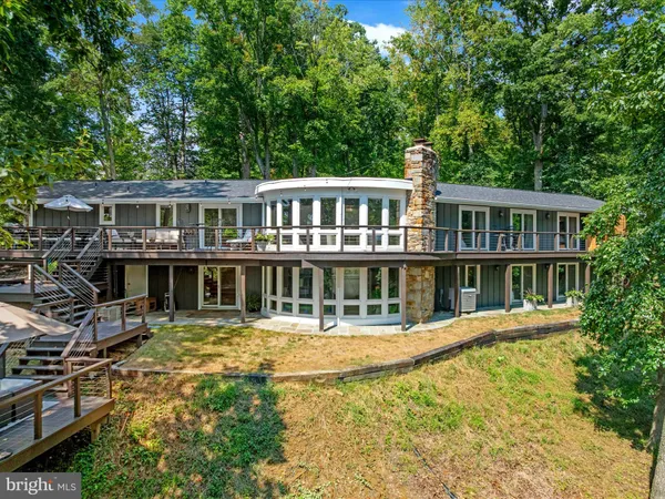 a living room with furniture and large windows