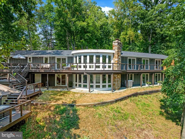 a living room with furniture and large windows