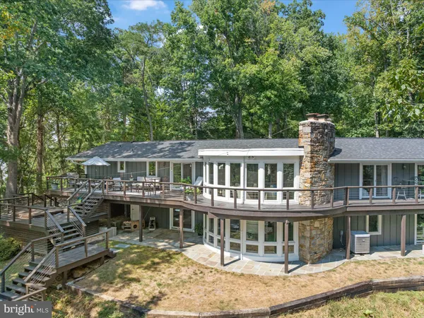 an aerial view of green landscape with trees houses and lake view