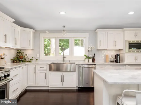 a white bath tub sitting in a bathroom next to a window