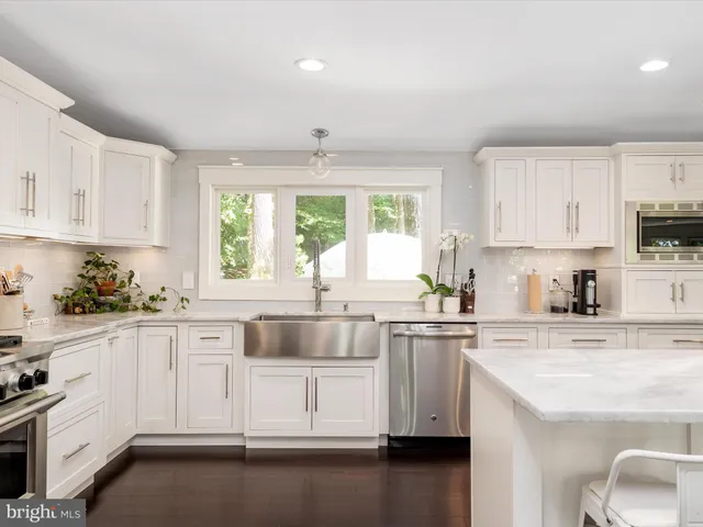 a white bath tub sitting in a bathroom next to a window