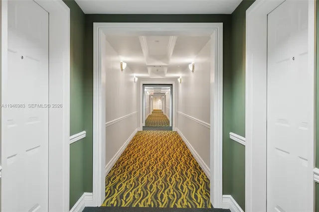 a view of hallway with wooden floor