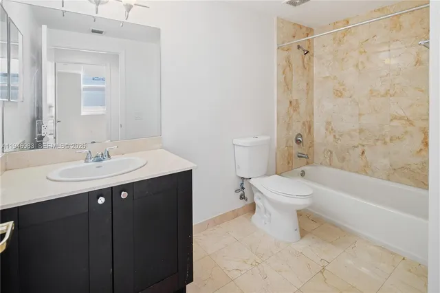 a room with pool table and windows