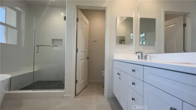a bathroom with a shower sink and mirror