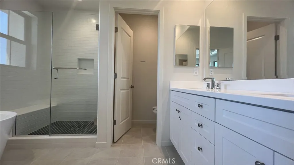110 Sunnyside Irvine, CA 92620 - Photo 12 of 15 a bathroom with a shower sink and mirror
