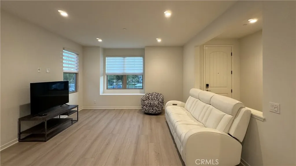 110 Sunnyside Irvine, CA 92620 - Photo 4 of 15 a living room with furniture and a flat screen tv