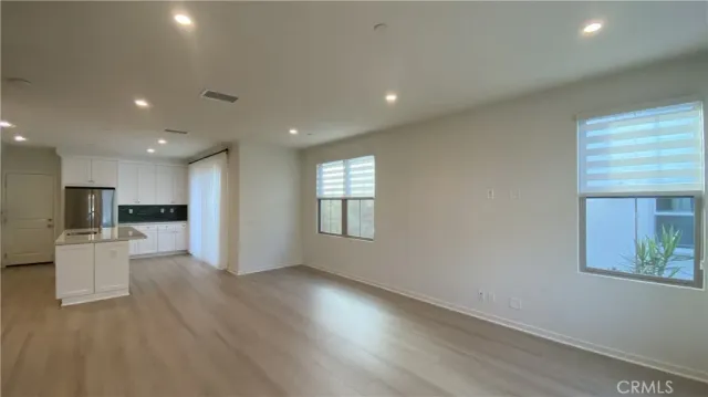 a view of kitchen with wooden floor and windows