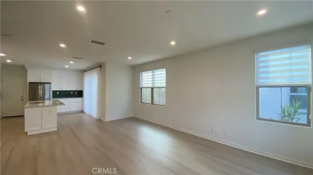 a view of kitchen with wooden floor and windows