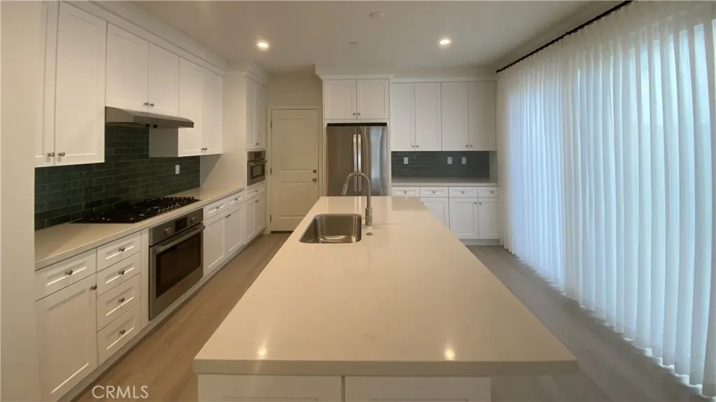 110 Sunnyside Irvine, CA 92620 - Photo 7 of 15 a kitchen with a sink and stainless steel appliances