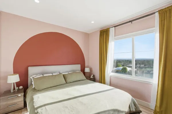a bed sitting in a bedroom next to a window
