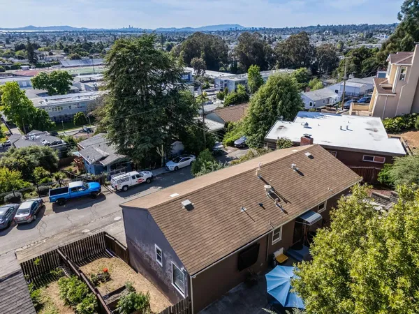 an aerial view of a house with a yard
