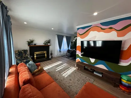 a living room with furniture pool table and a fireplace