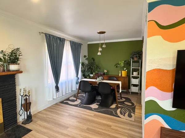 a view of a dining room with furniture window and wooden floor