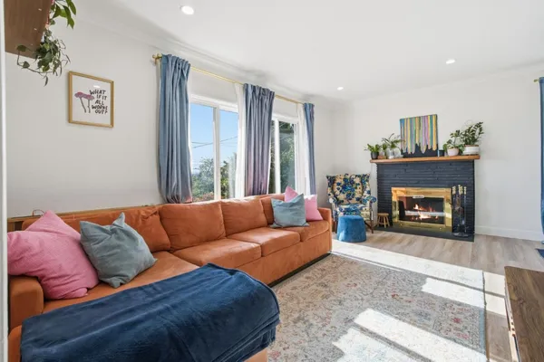 a living room with furniture and a fireplace