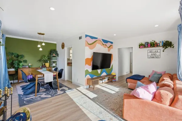 a living room with furniture and a flat screen tv