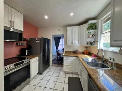 a kitchen with a sink stove and refrigerator