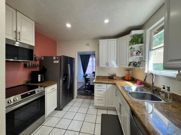 a kitchen with a sink stove and refrigerator