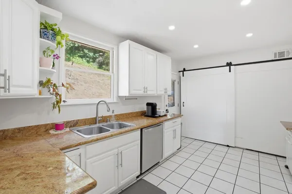 a kitchen with a sink cabinets and window