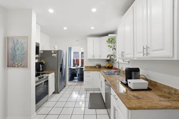 a kitchen with refrigerator and cabinets