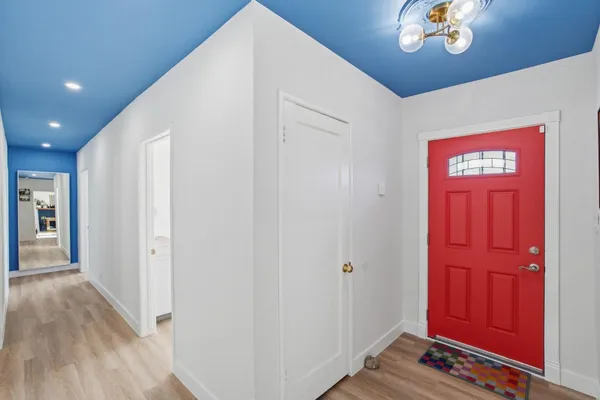 a view of a hallway with wooden floor