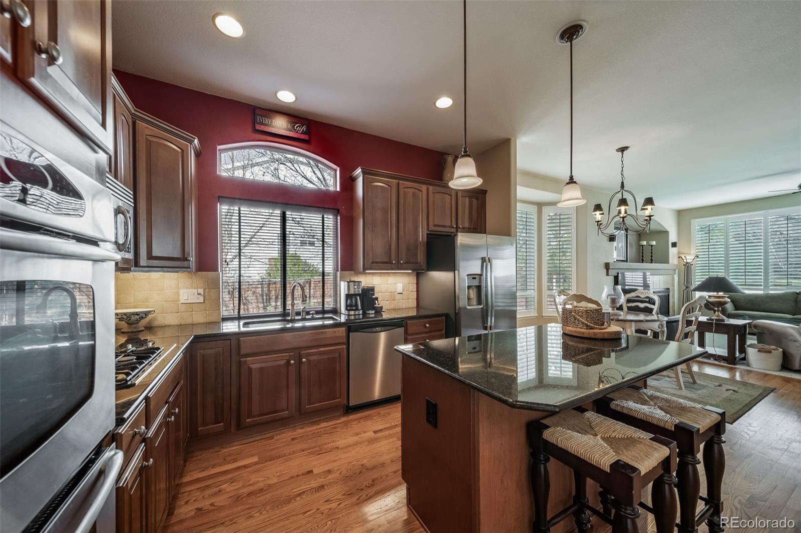 16598 Hitching Post Circle Parker, CO 80134 - Photo 17 of 50 a kitchen with stainless steel appliances granite countertop sink stove and refrigerator
