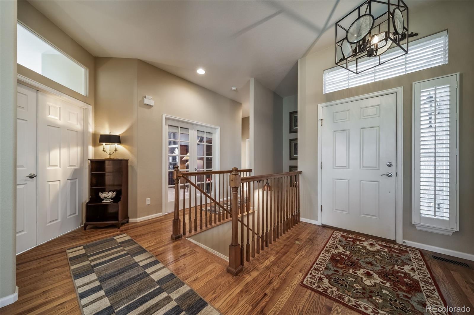 16598 Hitching Post Circle Parker, CO 80134 - Photo 4 of 50 a view of a hallway with wooden floor and staircase