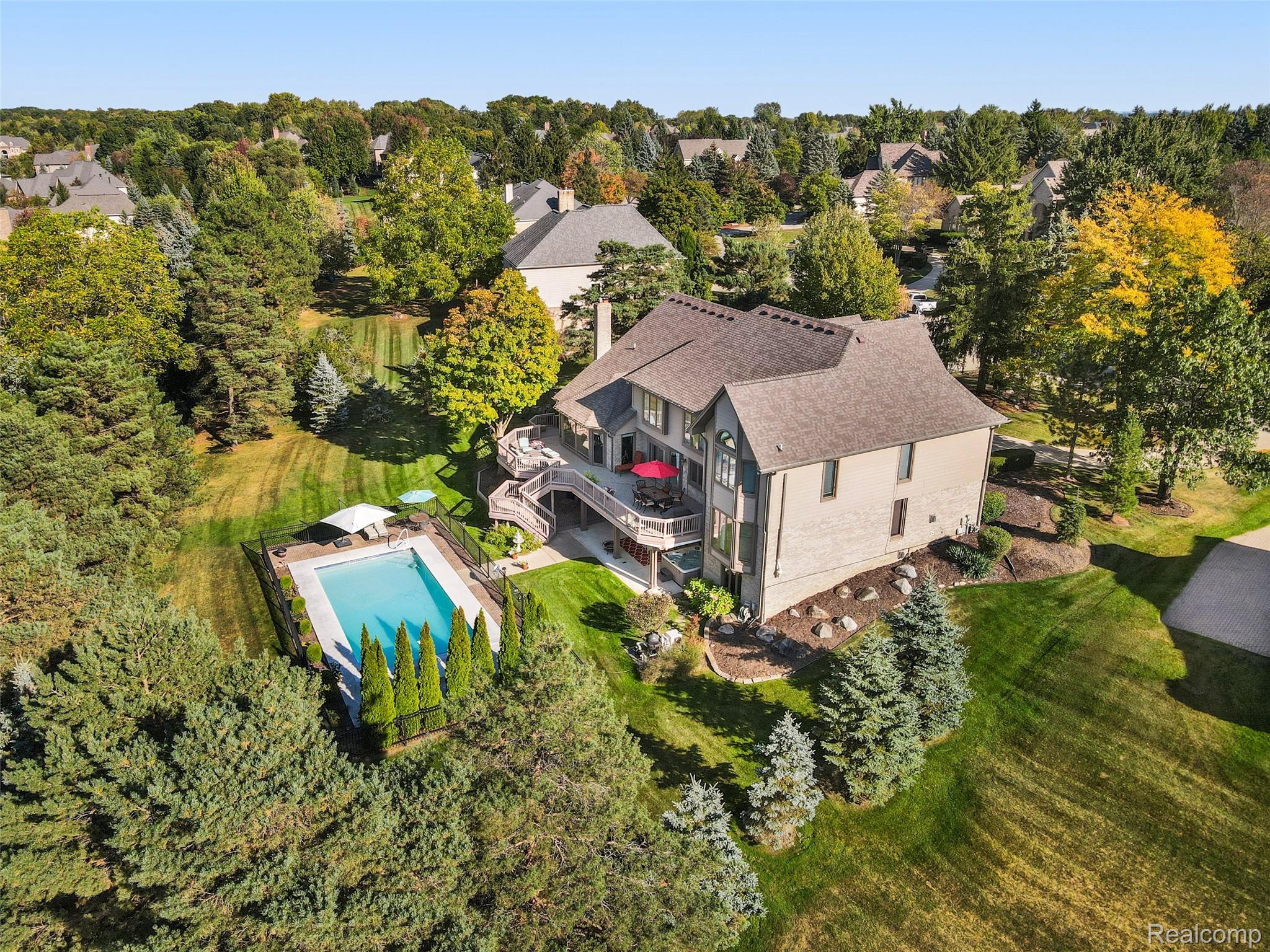 5724 Murfield Drive Rochester, MI 48306 - Photo 16 of 99 Aerial view of a pool and a tree filled landscape