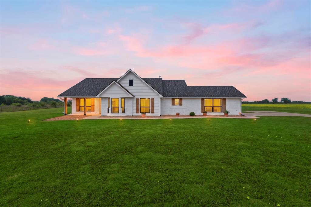2990 Wilson Road Palmer, TX 75152 - Photo 1 of 40 a front view of a house with a yard and garage