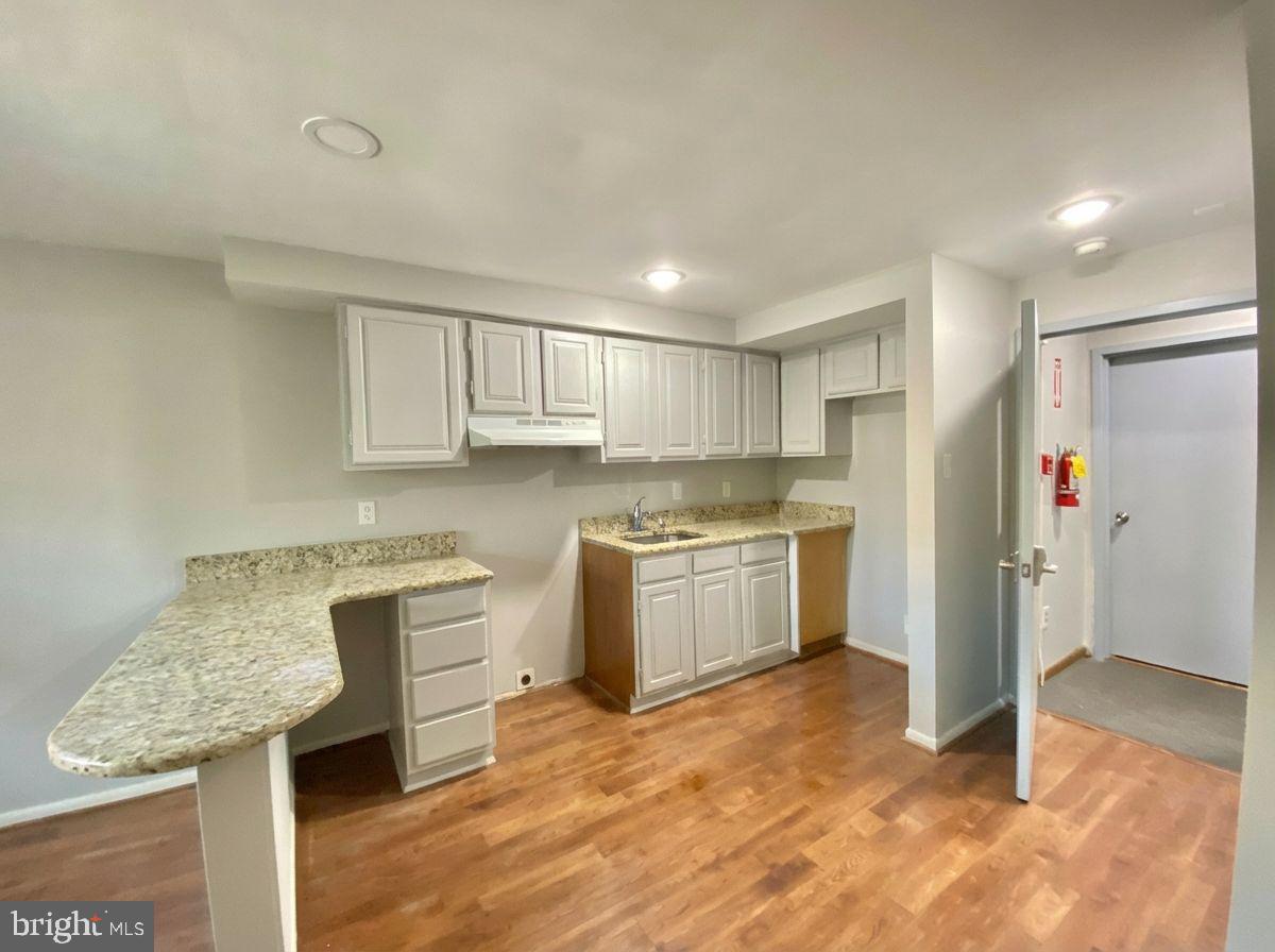 713 Walnut Street, Unit 3F Philadelphia, PA 19106 - Photo 1 of 12 a kitchen with a refrigerator sink and cabinets