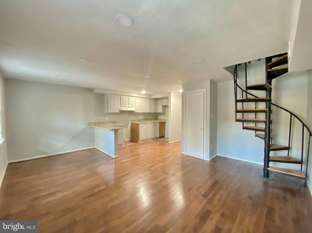 713 Walnut Street, Unit 3F Philadelphia, PA 19106 - Photo 2 of 12 a view of empty room with wooden floor and kitchen