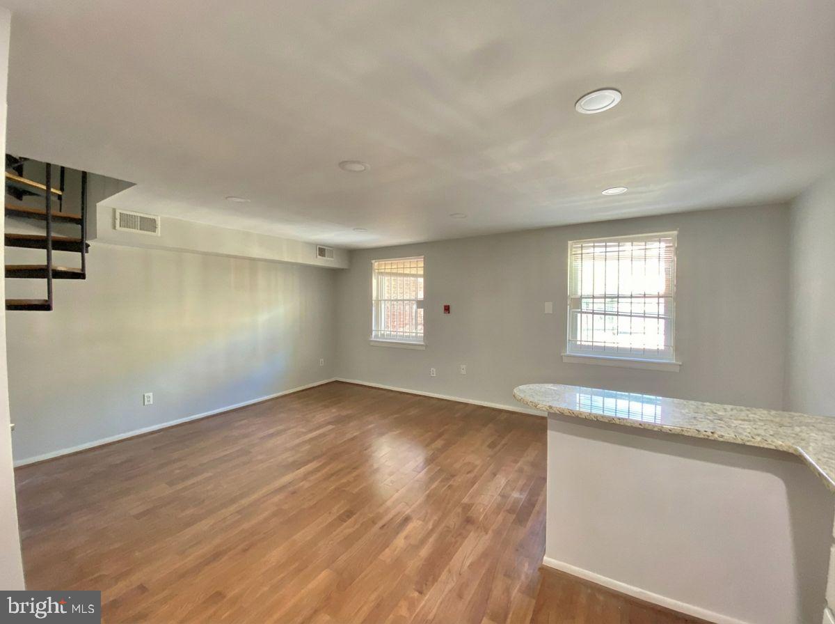 713 Walnut Street, Unit 3F Philadelphia, PA 19106 - Photo 10 of 12 a view of an empty room with wooden floor and a window