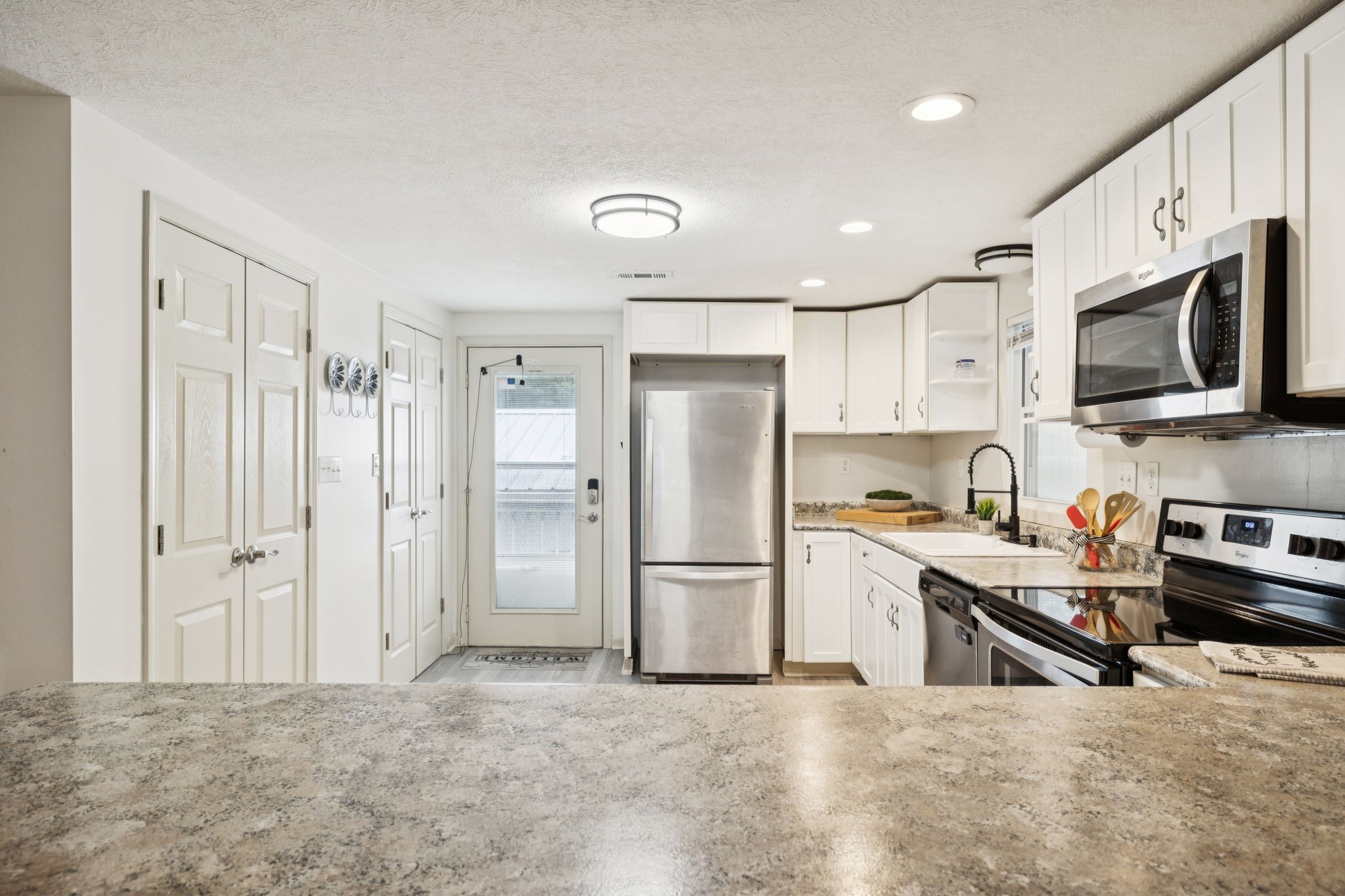 617 Still Point Road Smithville, TN 37166 - Photo 29 of 72 a kitchen with stainless steel appliances granite countertop a refrigerator a stove top oven a sink and dishwasher