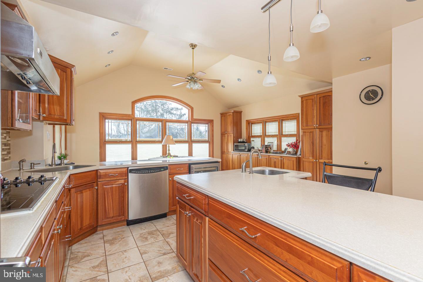 612 Double Woods Road Langhorne, PA 19047 - Photo 14 of 44 a large kitchen with kitchen island a large counter top space a large window appliances and cabinets