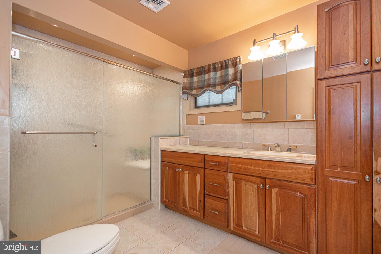 612 Double Woods Road Langhorne, PA 19047 - Photo 27 of 44 a bathroom with a granite countertop toilet sink and mirror