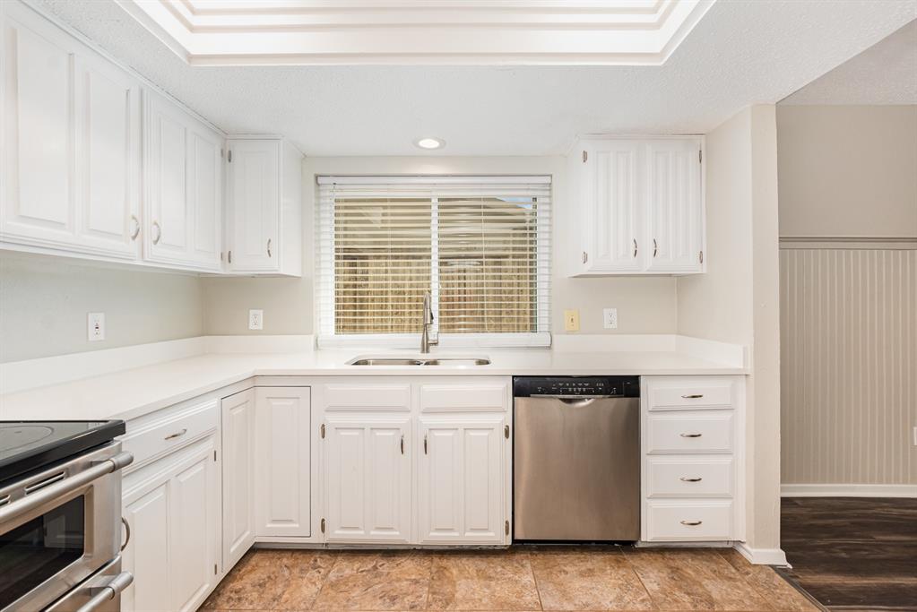 229 South Heartz Road Coppell, TX 75019 - Photo 11 of 19 Kitchen featuring appliances with stainless steel finishes, white cabinets, recessed lighting, light countertops, and a textured ceiling