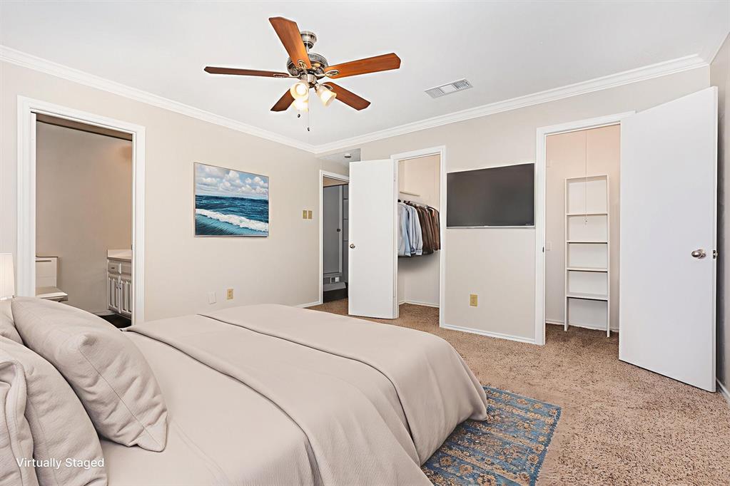229 South Heartz Road Coppell, TX 75019 - Photo 13 of 19 Bedroom featuring crown molding, a spacious closet, light colored carpet, ensuite bath, and a ceiling fan