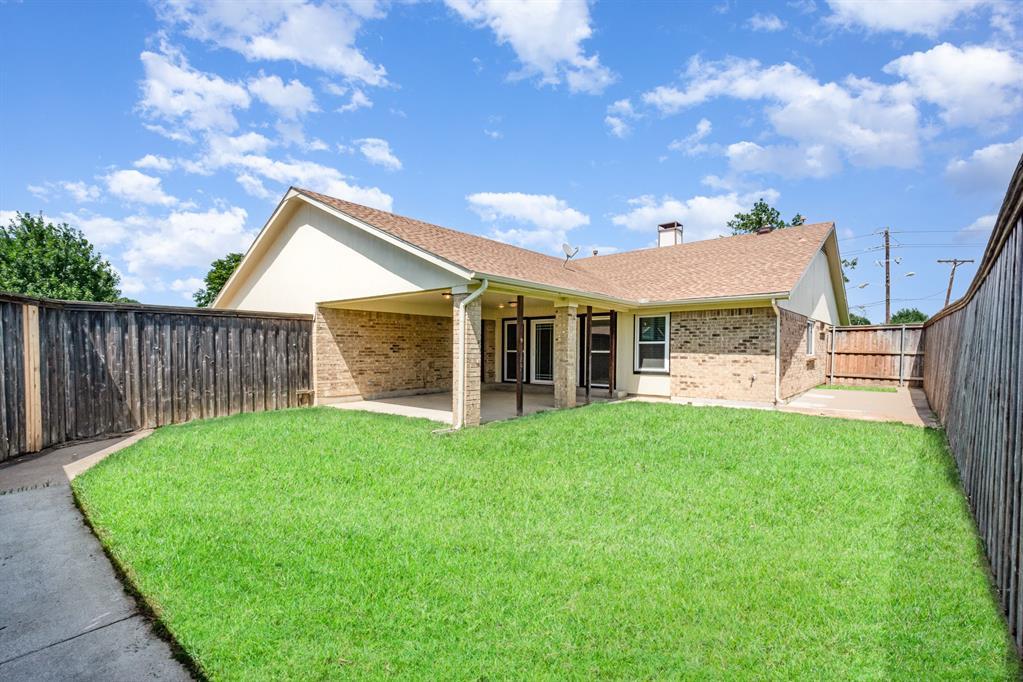 229 South Heartz Road Coppell, TX 75019 - Photo 18 of 19 Back of house featuring brick siding, a patio, a fenced backyard, a shingled roof, and a chimney
